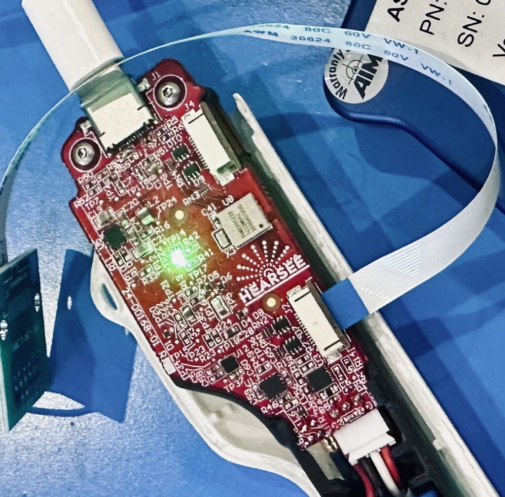 Red printed circuit board labeled “Hearsee” with connectors.