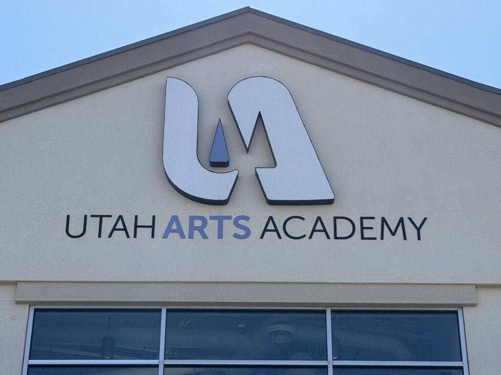 Utah Arts Academy logo on building exterior.