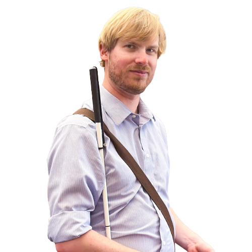 Man standing with a white cane over his shoulder, wearing a light blue button-down shirt and shoulder strap, facing slightly toward the camera against a transparent background.